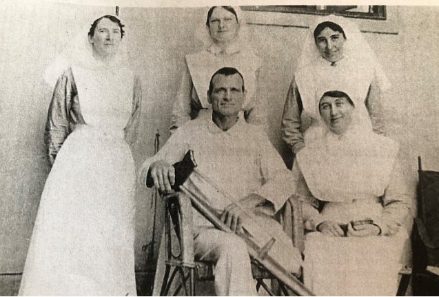 Group portrait of nurses and a patient at No. 3 AGH which features Major Michael Shanahan