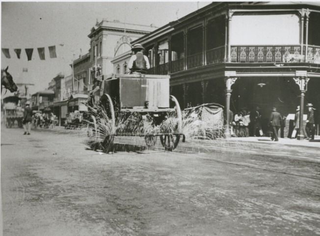 Horse drawn water tanker watering the streets