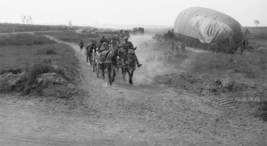 Transport of the 2nd Australian Infantry Brigade on their way to the rest area, passing an observation balloon