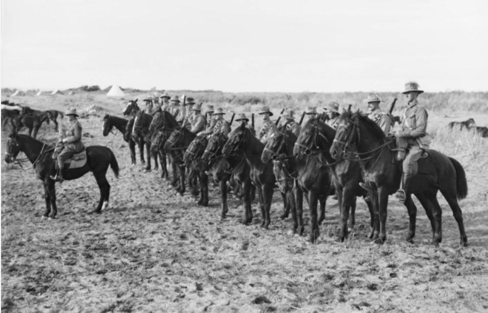 Group portrait of the 8th Mobile Veterinary Section with the 3rd Australian Light Horse Brigade on their horses in Palestine