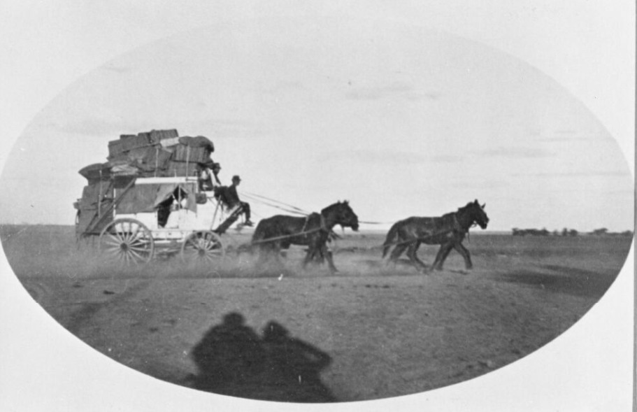 'Cobb and Co. coach near Longreach, Queensland, ca. 1916.' National Library Australia The cane baskets are mail baskets.