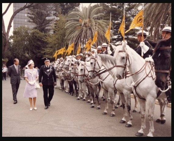'Queen Elizabeth II and the Duke of Edinburgh inspecting a row of mounted police in Perth, Western Australia, accompanied by the Police Commissioner of Western Australia Owen Leitch. Taken during the Queen and Duke's 1977 official visit to Australia. Comments: Queen Elizabeth visited Australia as part of her Silver Jubilee tour of the Commonwealth. While in Australia, she presided over the State Opening of Parliament in Canberra, visited all capital cities plus Launceston, Newcastle and other regional centres. Inscription: In an album labelled "Visit to Australia of Her Majesty The Queen and His Royal Highness The Duke of Edinburgh, 7 March to 30 March 1977".' Uni of Melbourne.