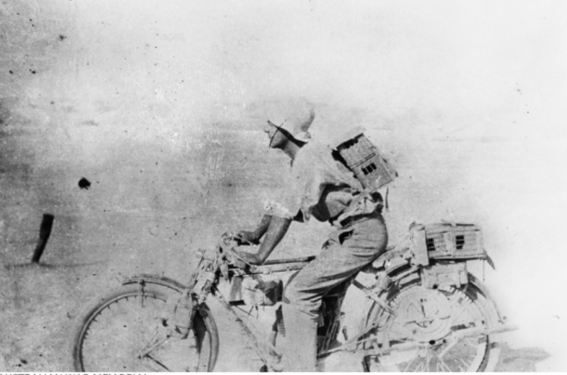 'Jordan Valley. A motor cyclist transporting carrier pigeons in small cages at Wadi Mellahah. September 1918.' AWM